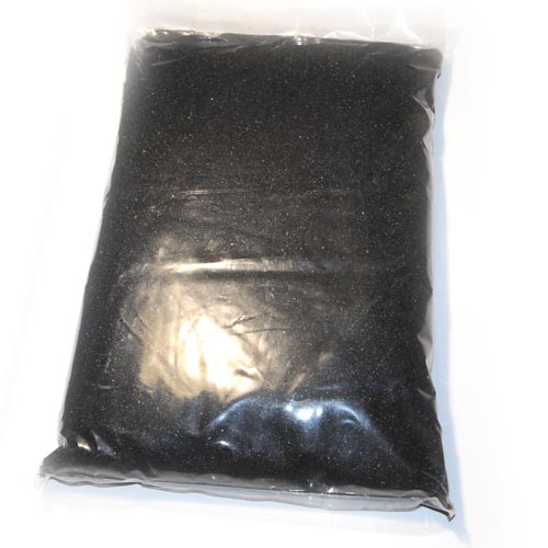 Bag of black sand for fire pits, fireplaces, and fire bowls; ideal for modern outdoor features.