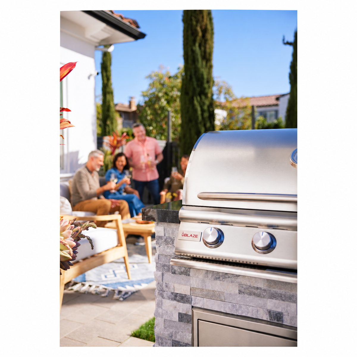 Blaze 32-Inch Built-In Gas Grill installed in outdoor kitchen with guests entertaining