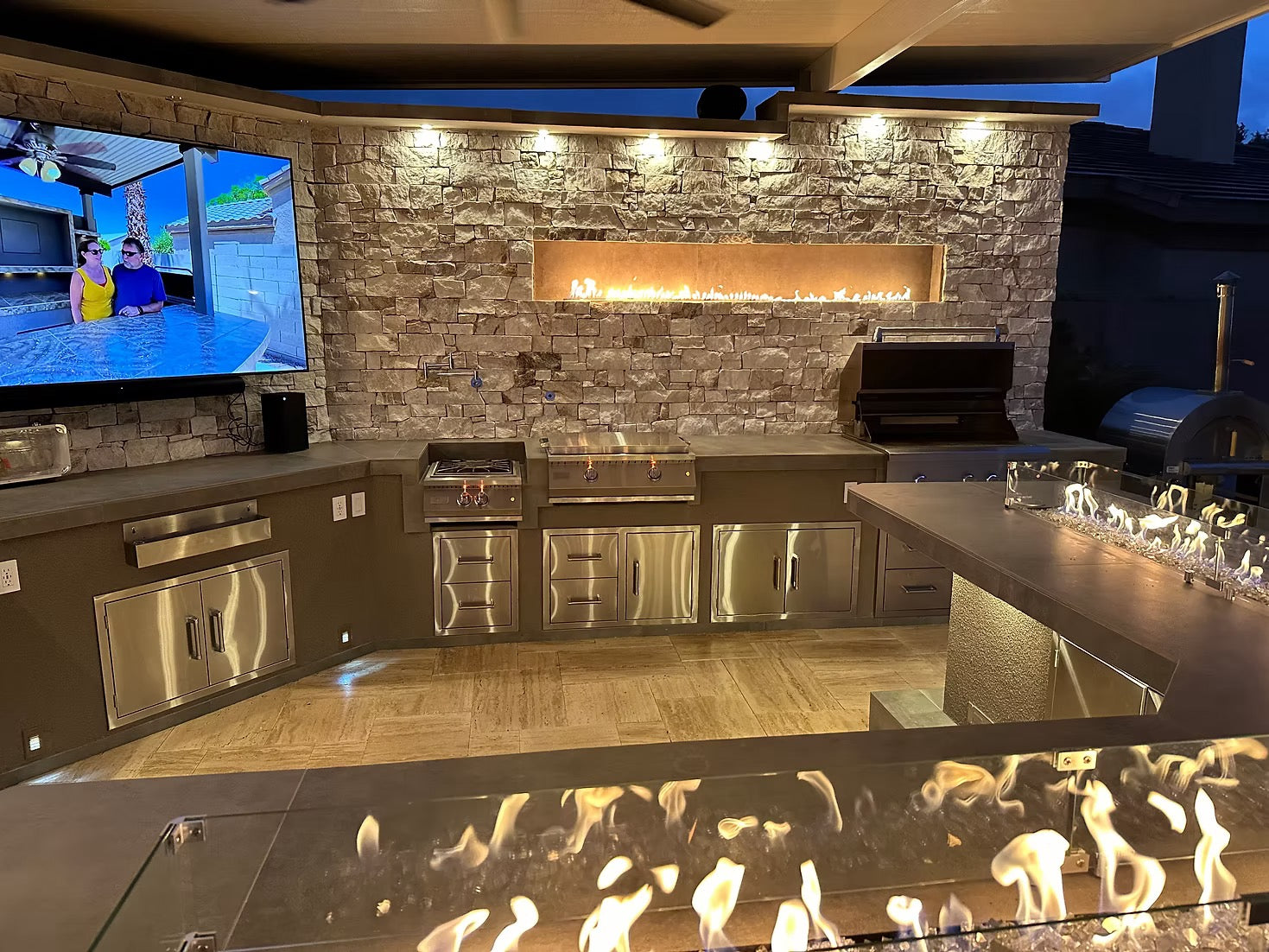 Gold-black Pinnacle outdoor kitchen built in stainless steel grill wine fridge luxury patio dining