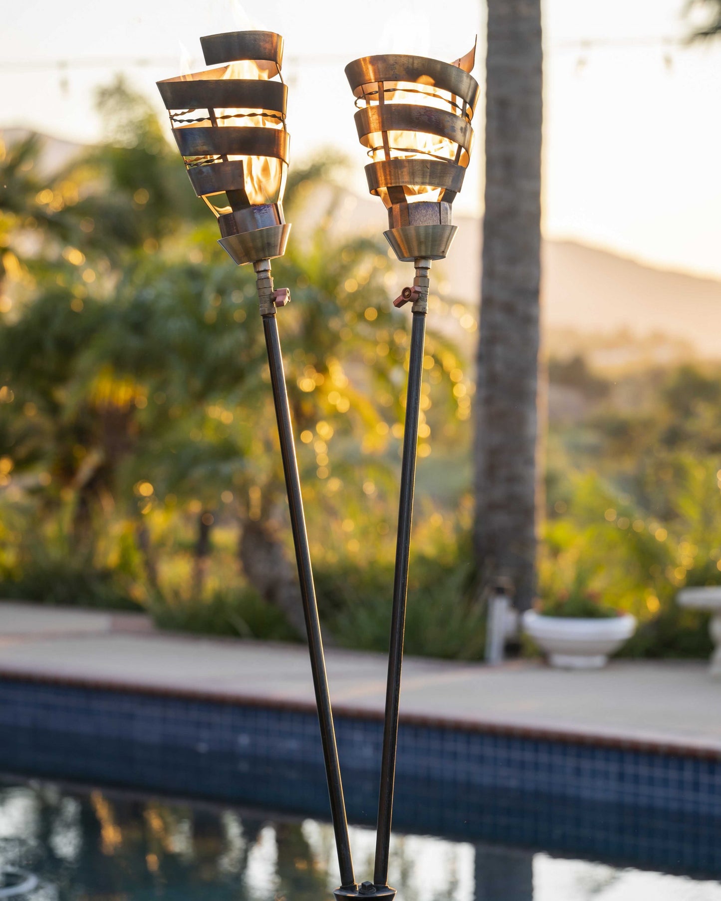 Corten steel Spiral Torch outdoor fire sculpture with flame at The Pinnacle Patio