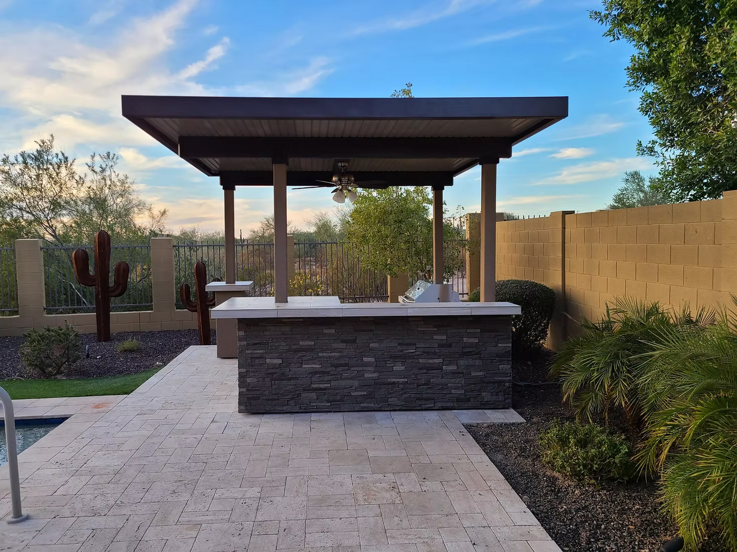 Gold-black Pinnacle outdoor kitchen built in stainless steel grill wine fridge luxury patio dining