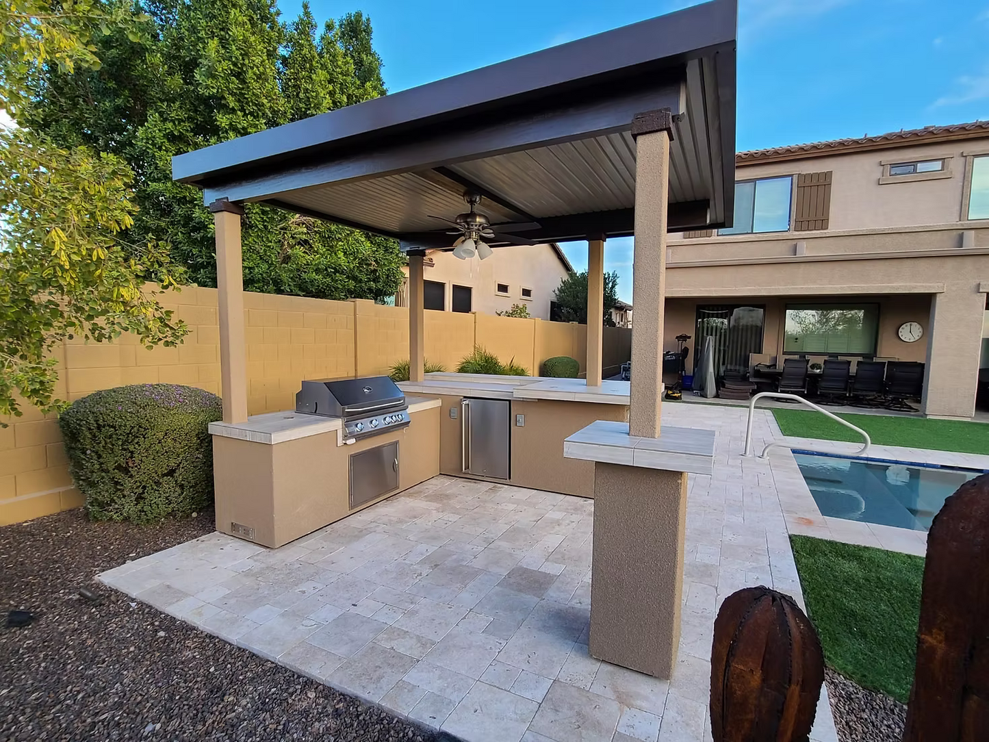 Gold-black Pinnacle outdoor kitchen built in stainless steel grill wine fridge luxury patio dining