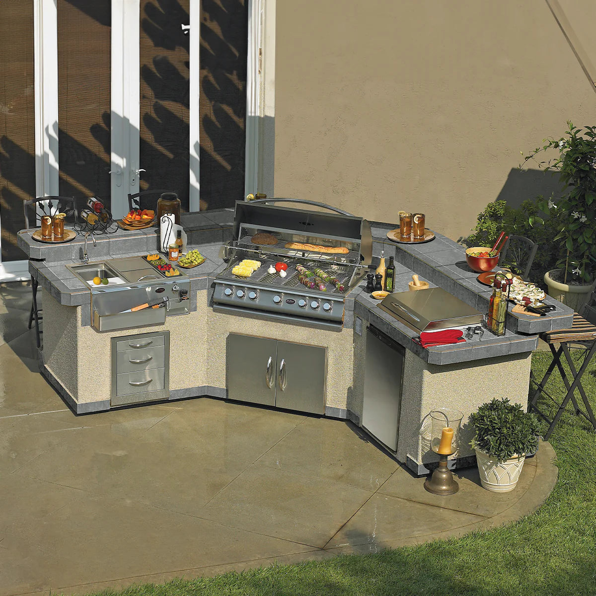 Cal Flame luxury outdoor kitchen with stainless steel grill, in an elegant backyard setting