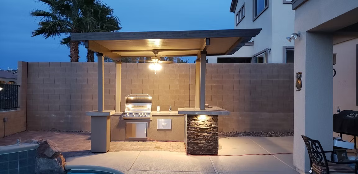 Stainless steel grill accessory set displayed on a luxury outdoor kitchen