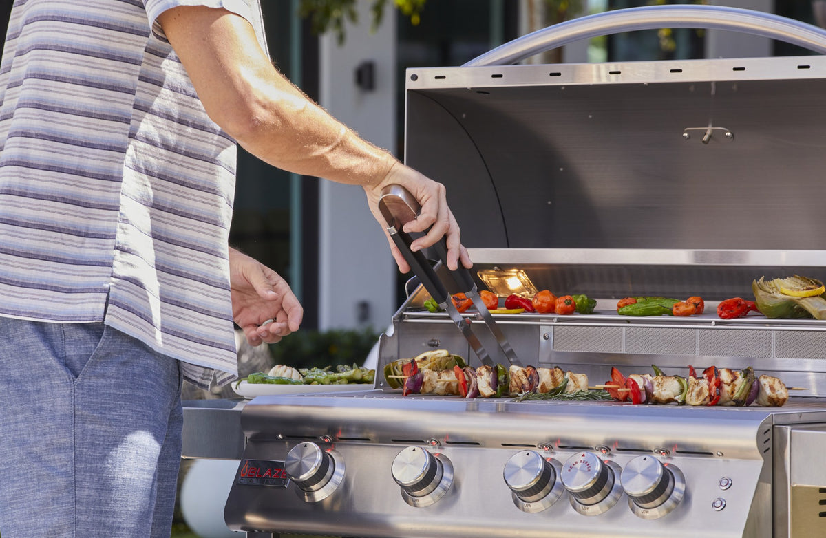 Blaze LBM 32-Inch 4-Burner Grill being used for outdoor cooking