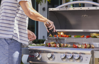 Blaze LBM 32-Inch 4-Burner Grill being used for outdoor cooking