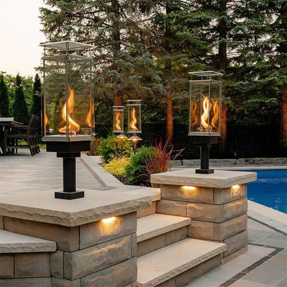 Tempest 20K outdoor gas torches pillar mounted beside luxury swimming pool
