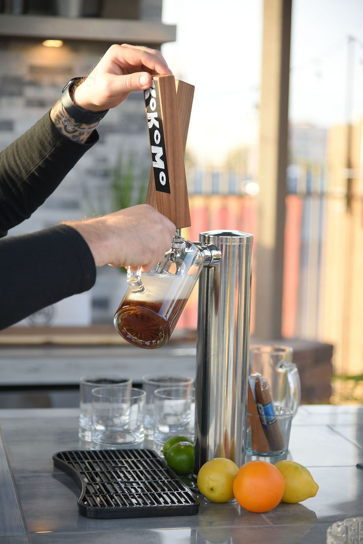 Kokomo outdoor kitchen beer tap dispensing a drink on a luxury custom outdoor kitchen island