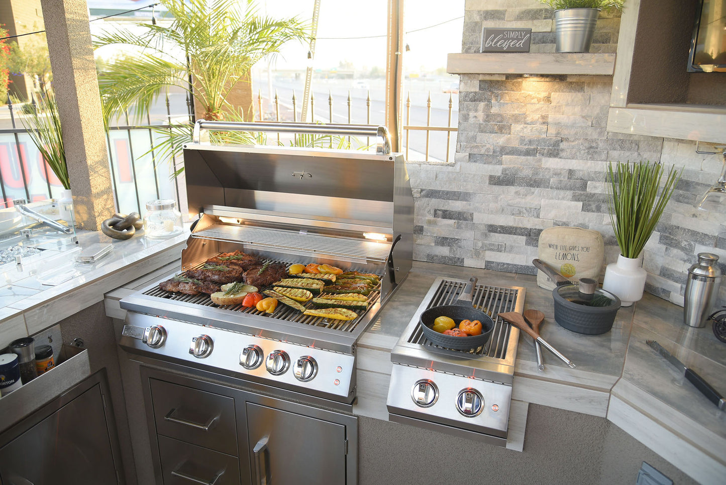 Modern outdoor kitchen with a grill and cooking area.