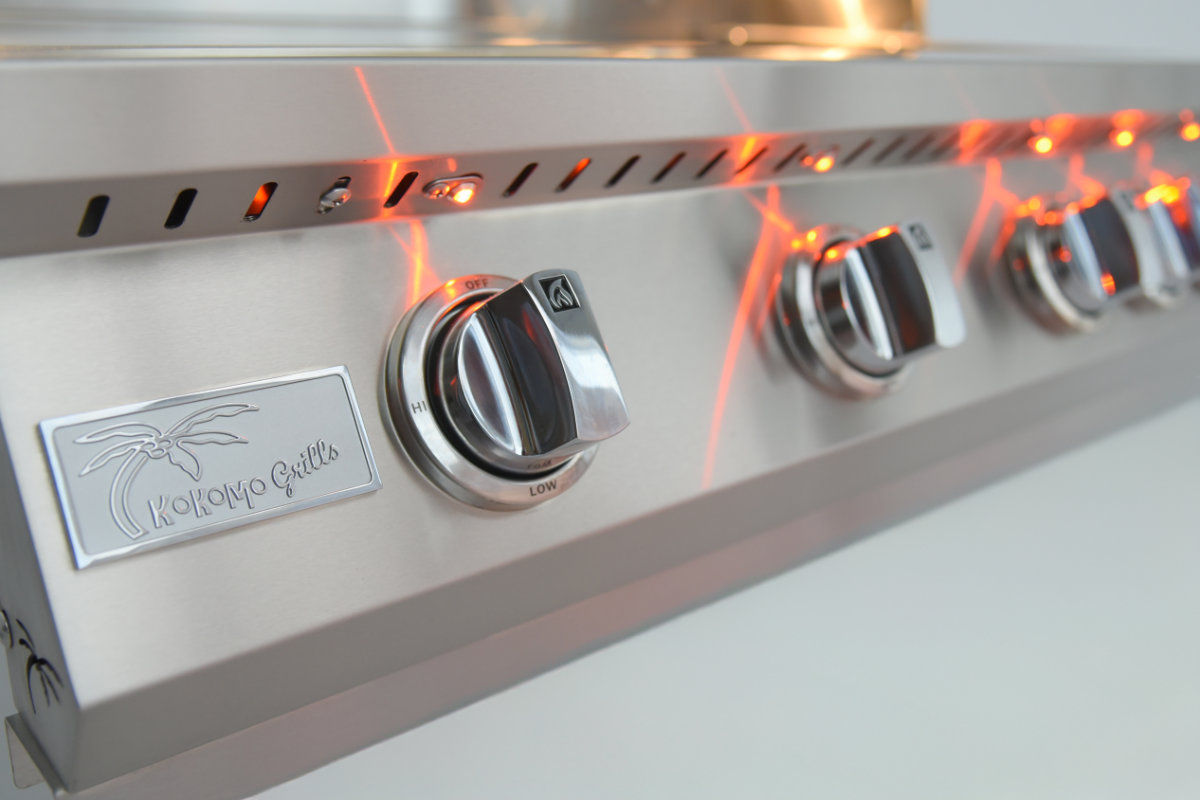 Stainless steel outdoor grill with glowing elements on a white background close up