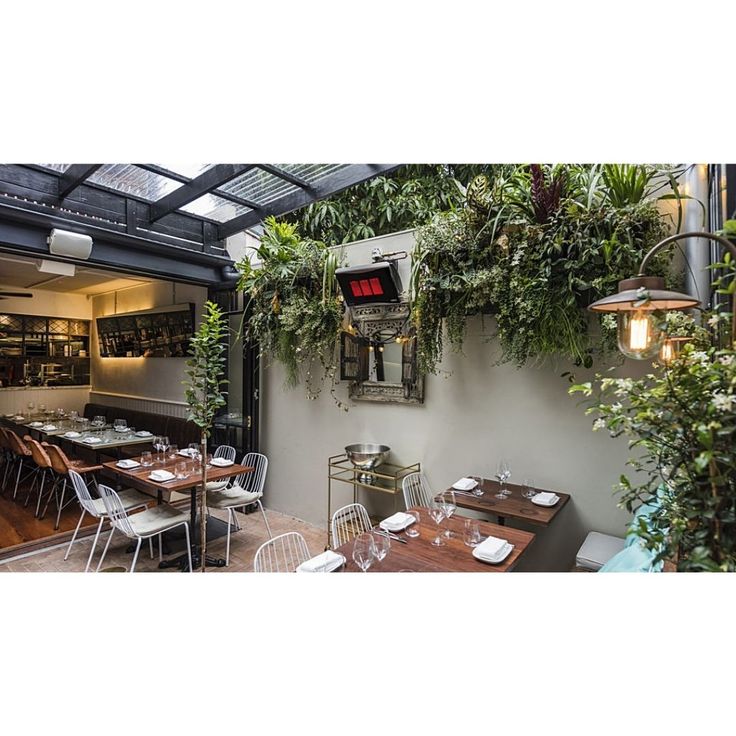 Bromic Platinum 300 Smart-Heat natural gas heaters installed above a luxury covered outdoor patio seating area