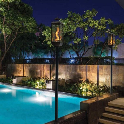 Tempest 20K outdoor gas lanterns on ground posts beside luxury swimming pool