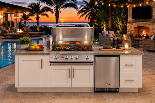 Bull Myrtle Beach DuraBull 8' Outdoor Kitchen Island at sunset beside a luxury pool, featuring a white HDPE marine-grade cabinet base, Coffee Brown granite countertop, Angus 4-burner stainless steel grill, outdoor refrigerator, and coastal resort-inspired entertaining space with fireplace, palm trees, and ambient landscape lighting.