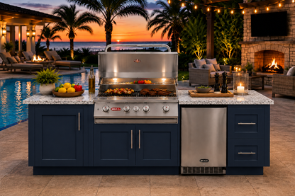 Luxury outdoor kitchen featuring a Bull Myrtle Beach DuraBull 8-foot island in Symphony Blue with a Galaxy White granite countertop, centered around a stainless-steel Angus grill and refrigerator. Set beside a resort-style pool at sunset with palm trees, string lights, a stone fireplace, and elegant lounge seating creating a warm coastal entertaining atmosphere.