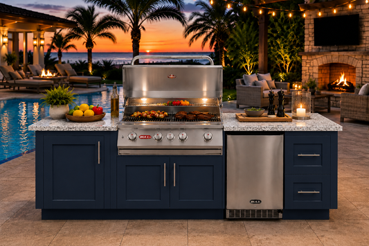 Luxury outdoor kitchen featuring a Bull Myrtle Beach DuraBull 8-foot island in Symphony Blue with a Galaxy White granite countertop, centered around a stainless-steel Angus grill and refrigerator. Set beside a resort-style pool at sunset with palm trees, string lights, a stone fireplace, and elegant lounge seating creating a warm coastal entertaining atmosphere.