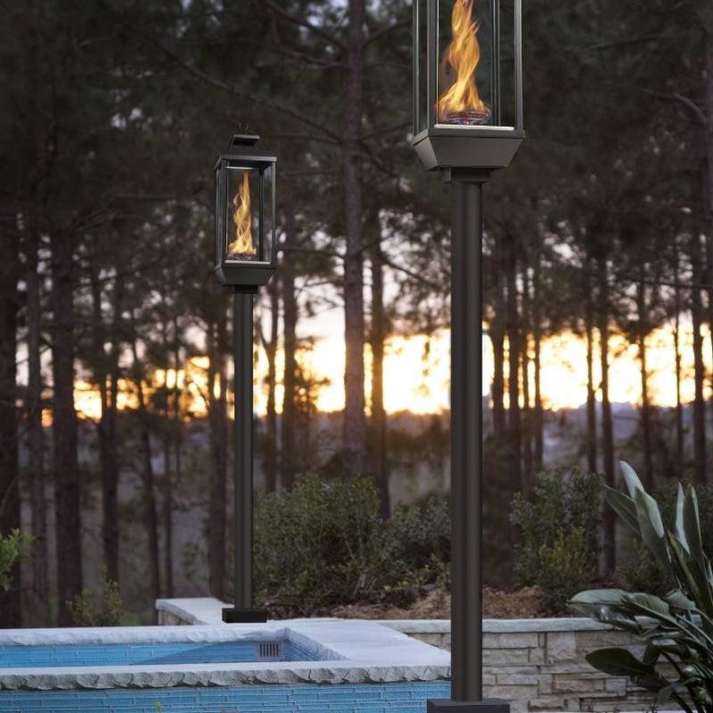Tempest 20K outdoor gas lanterns on ground posts beside luxury swimming pool