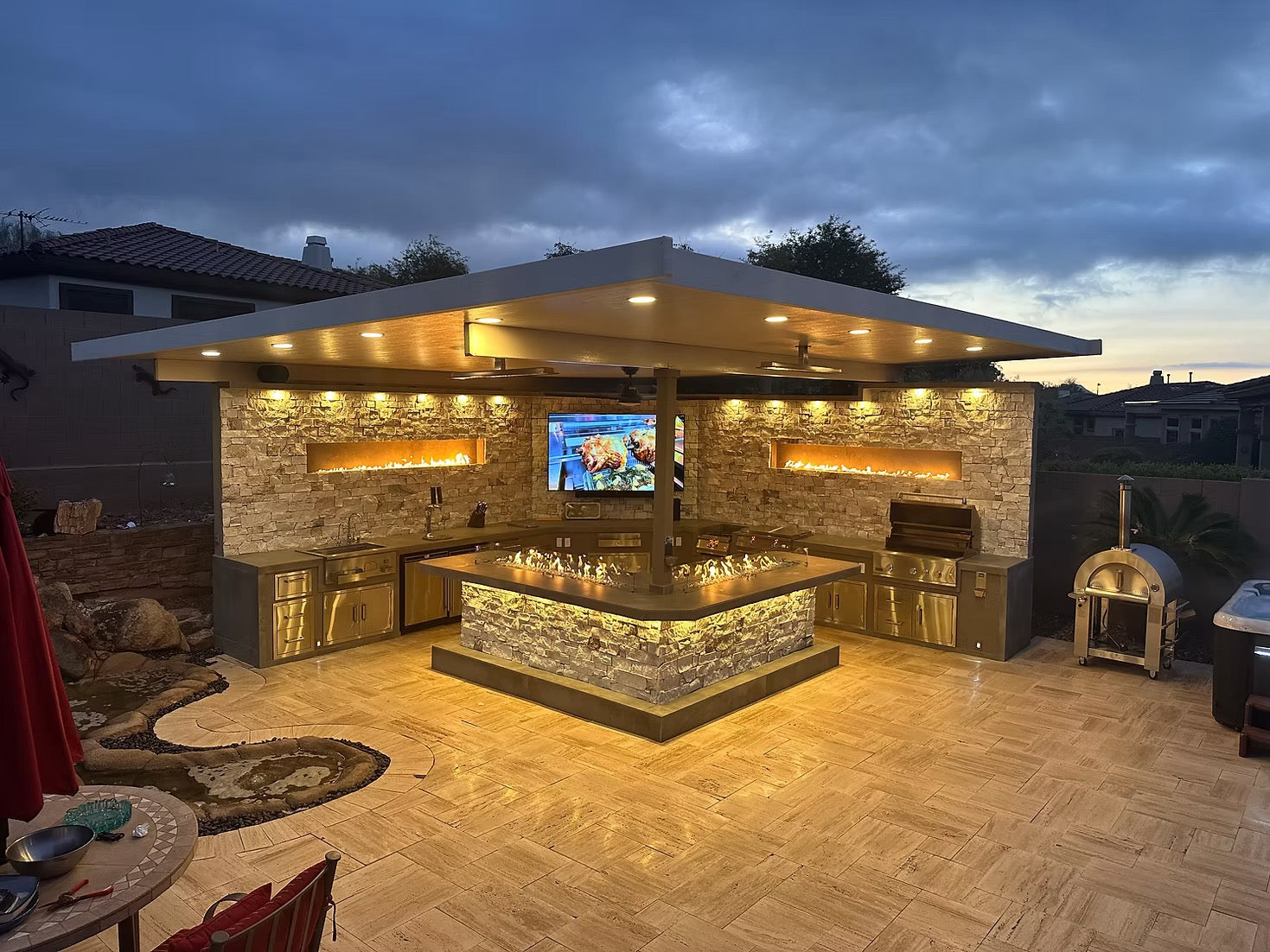 Gold-black Pinnacle outdoor kitchen built in stainless steel grill wine fridge luxury patio dining
