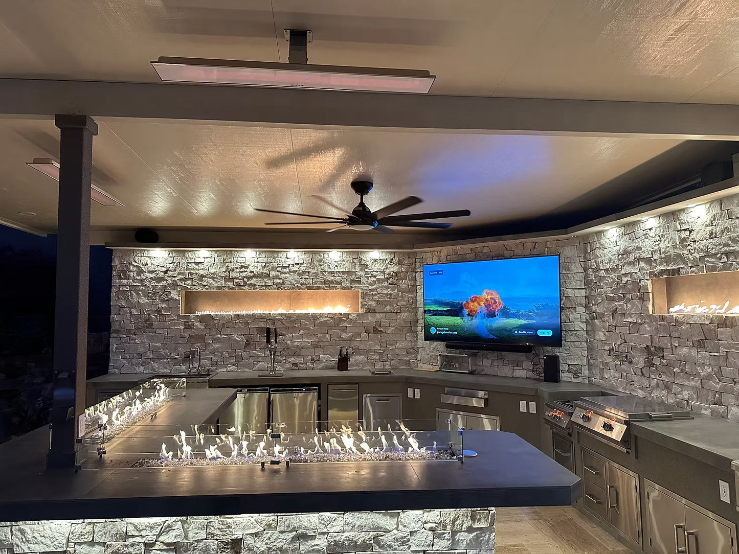 Gold-black Pinnacle outdoor kitchen built in stainless steel grill wine fridge luxury patio dining
