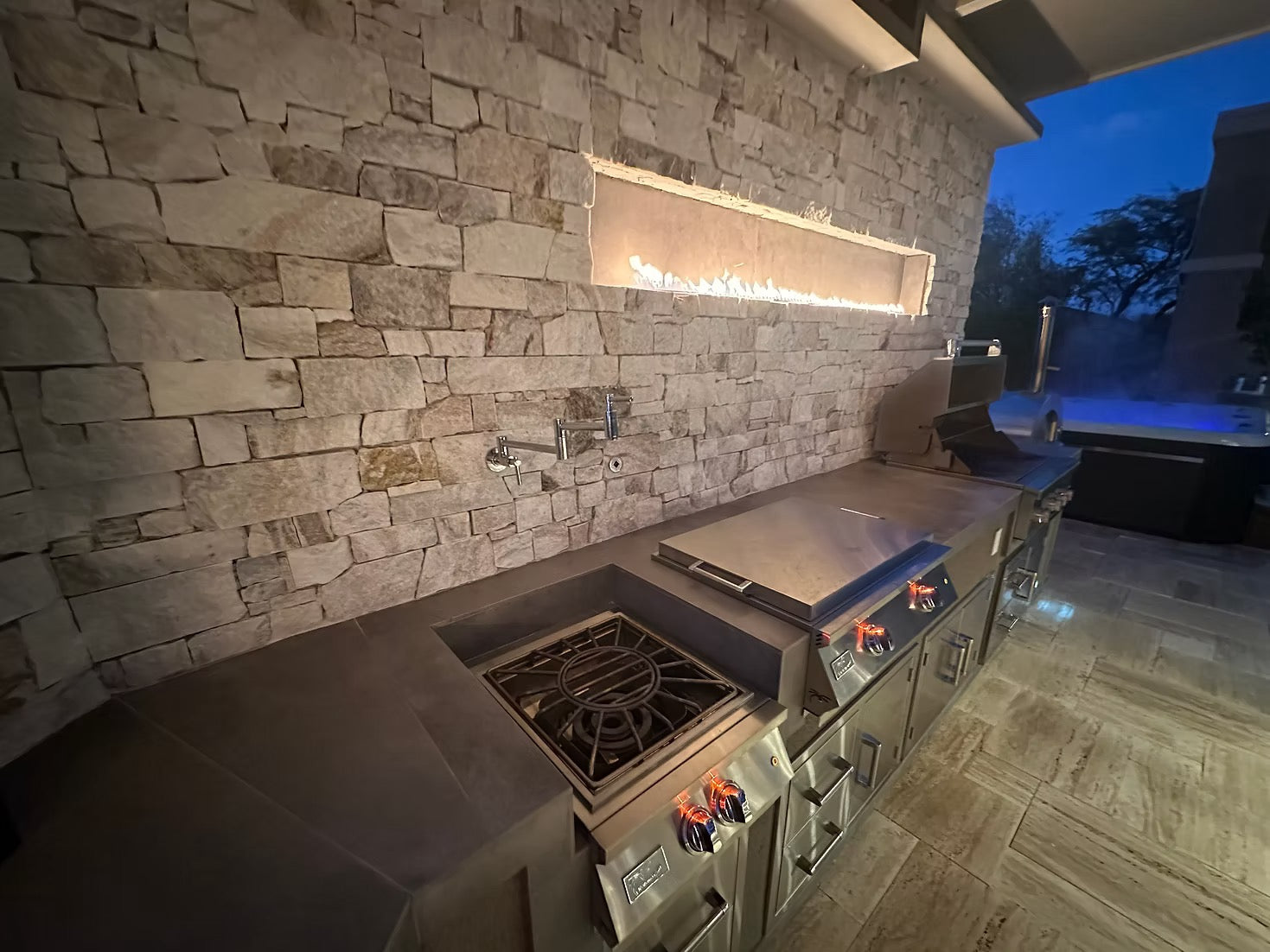 Gold-black Pinnacle outdoor kitchen built in stainless steel grill wine fridge luxury patio dining