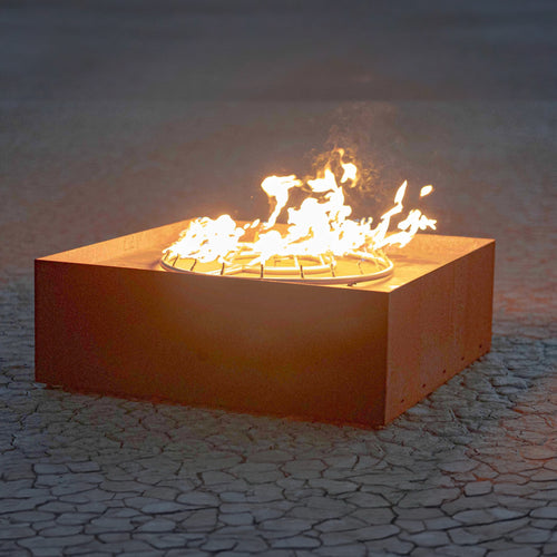 The Atomic corten steel fire sculpture with natural rust patina and active flames, modern outdoor art piece for luxury landscape design
