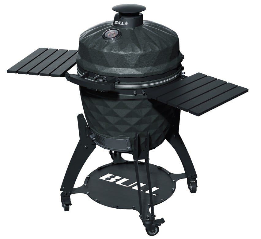 Bull 24-inch Complete Kamado Blackhorn Grill with cart shown closed, highlighting its premium ceramic body, integrated side shelves, storage shelf, and locking caster design.