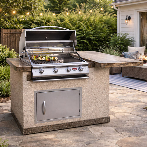 Cal Flame Kauai q 402  compact Outdoor Kitchen Island with 4 burner stainless steel grill and stone-style base in an elegant backyard setting