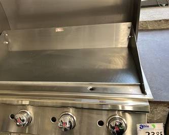 Bull 30-inch commercial griddle with hood open, showing the stainless steel flat-top cooking surface and burner controls.