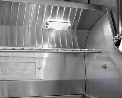 Wildfire Ranch PRO 36-inch grill interior with built-in cooking light illuminating the stainless steel firebox and warming rack.
