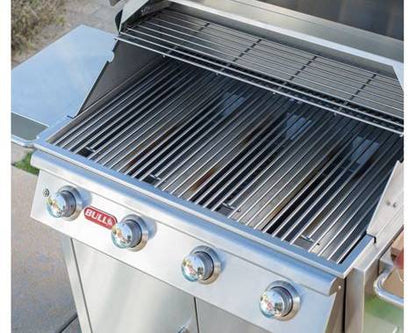 Close-up of Bull Lonestar Select stainless steel cooking grates and warming rack with four burner controls visible.
