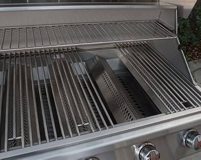 Bull Lonestar Select grill interior showing stainless steel cooking grates, warming rack and burner flame tamer system.