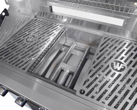 Wildfire Ranch PRO 36-inch grill interior showing stainless steel cooking grates lifted to reveal the burner and heat distribution system.