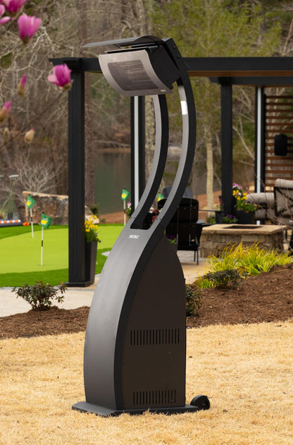 Bromic Eclipse portable outdoor heater in matte black finish beside a luxury patio and landscaped backyard setting.