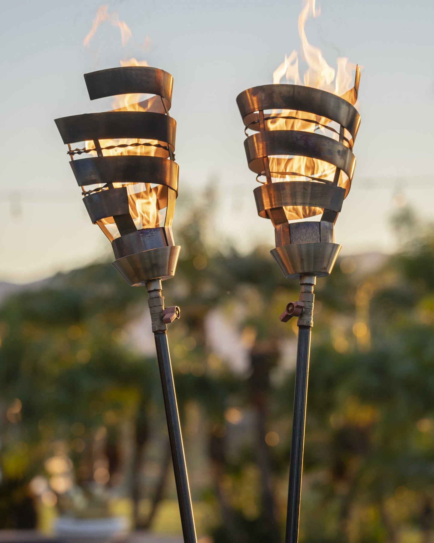 Spiral Torch luxury outdoor fire feature in corten steel with natural patina finish and twisted sculptural design