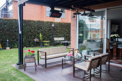 Outdoor patio area with furniture, table, and decorative elements on a patio.