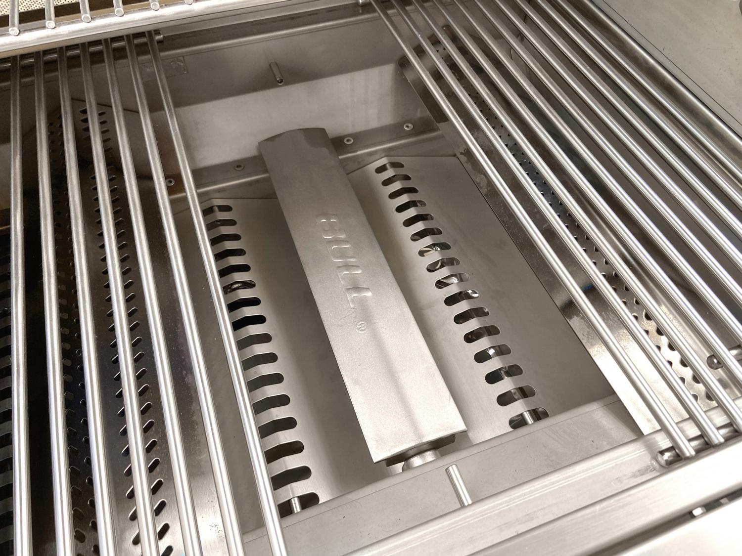 Close-up of Bull Angus grill interior showing stainless steel cooking grates, flame tamers and burner system.