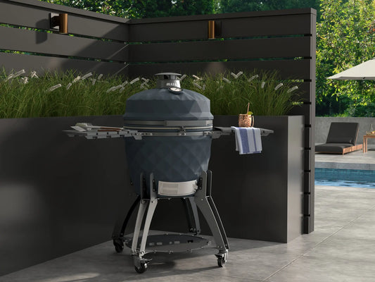 Bull 24" Complete Kamado Blackhorn Grill with Cart – lifestyle shot on an outdoor patio near a pool