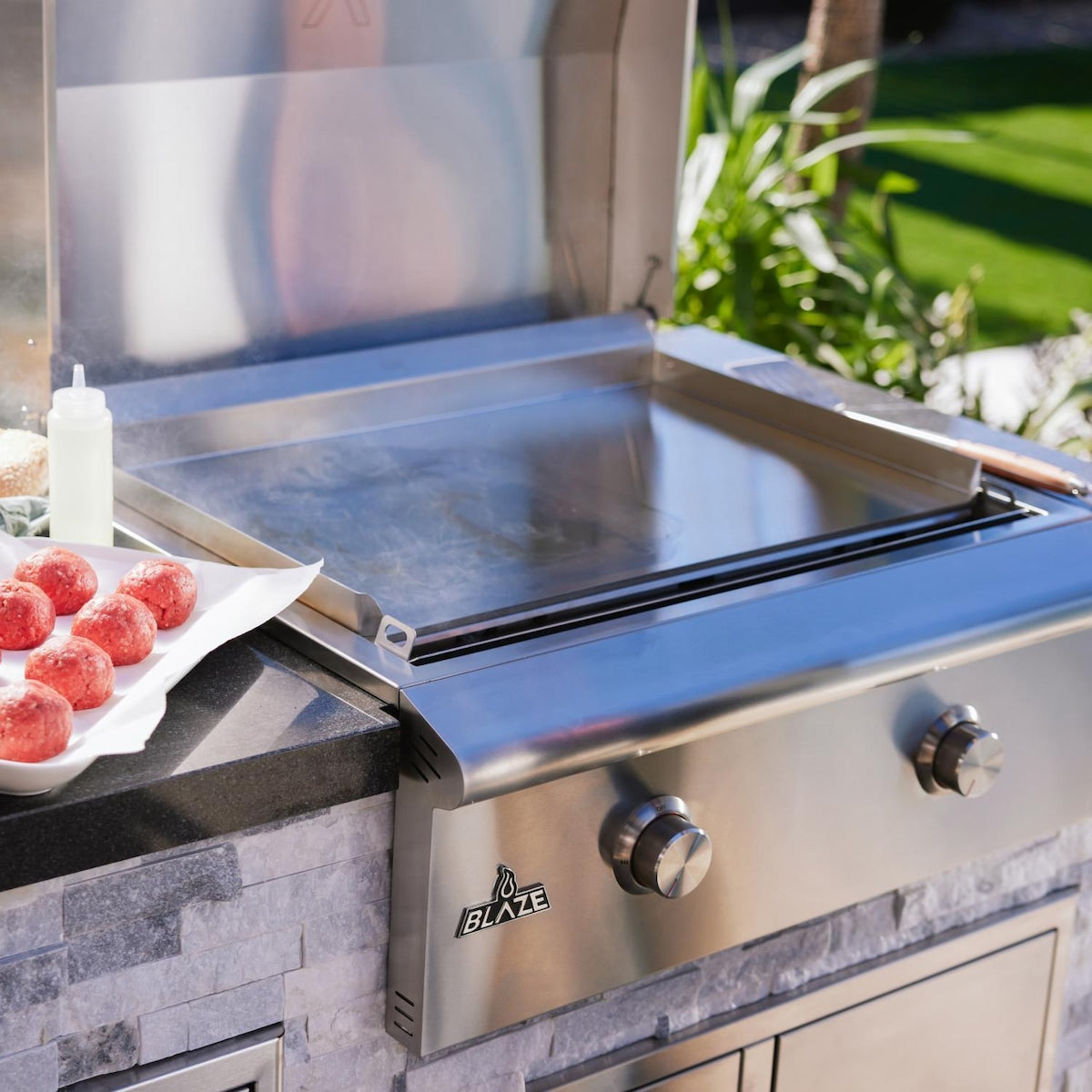 Blaze LTE+ 30-Inch Gas Griddle installed in outdoor kitchen with lid open