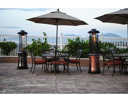 Lava Heat Italia Ember collapsible patio heaters providing warmth on an outdoor oceanfront dining terrace