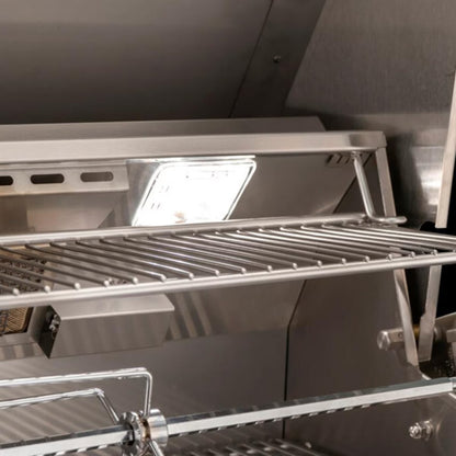AOG American Outdoor Grill interior with stainless steel warming rack, built-in LED light, and rotisserie rod