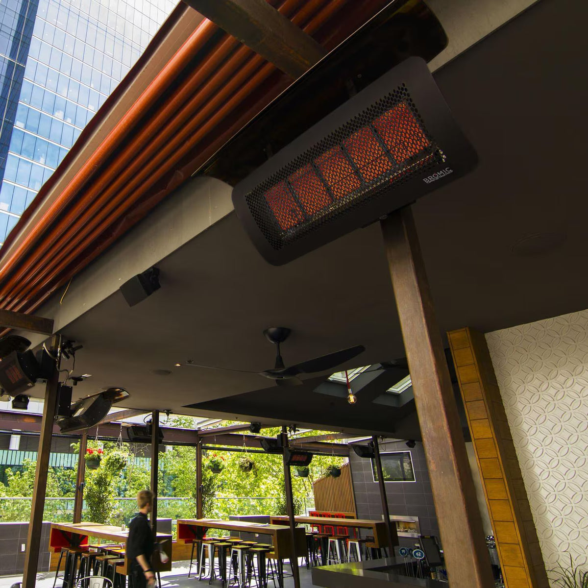 Bromic Tungsten 500 Smart-Heat natural gas heater providing radiant warmth over an outdoor dining and entertaining space