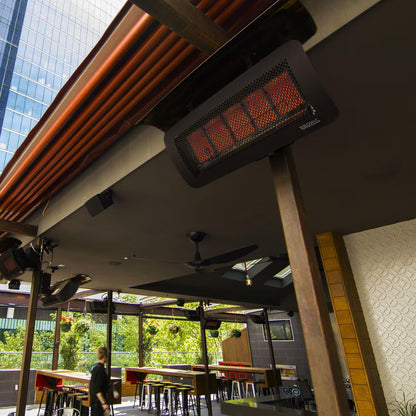 Bromic Tungsten 500 Smart-Heat natural gas heater providing radiant warmth over an outdoor dining and entertaining space